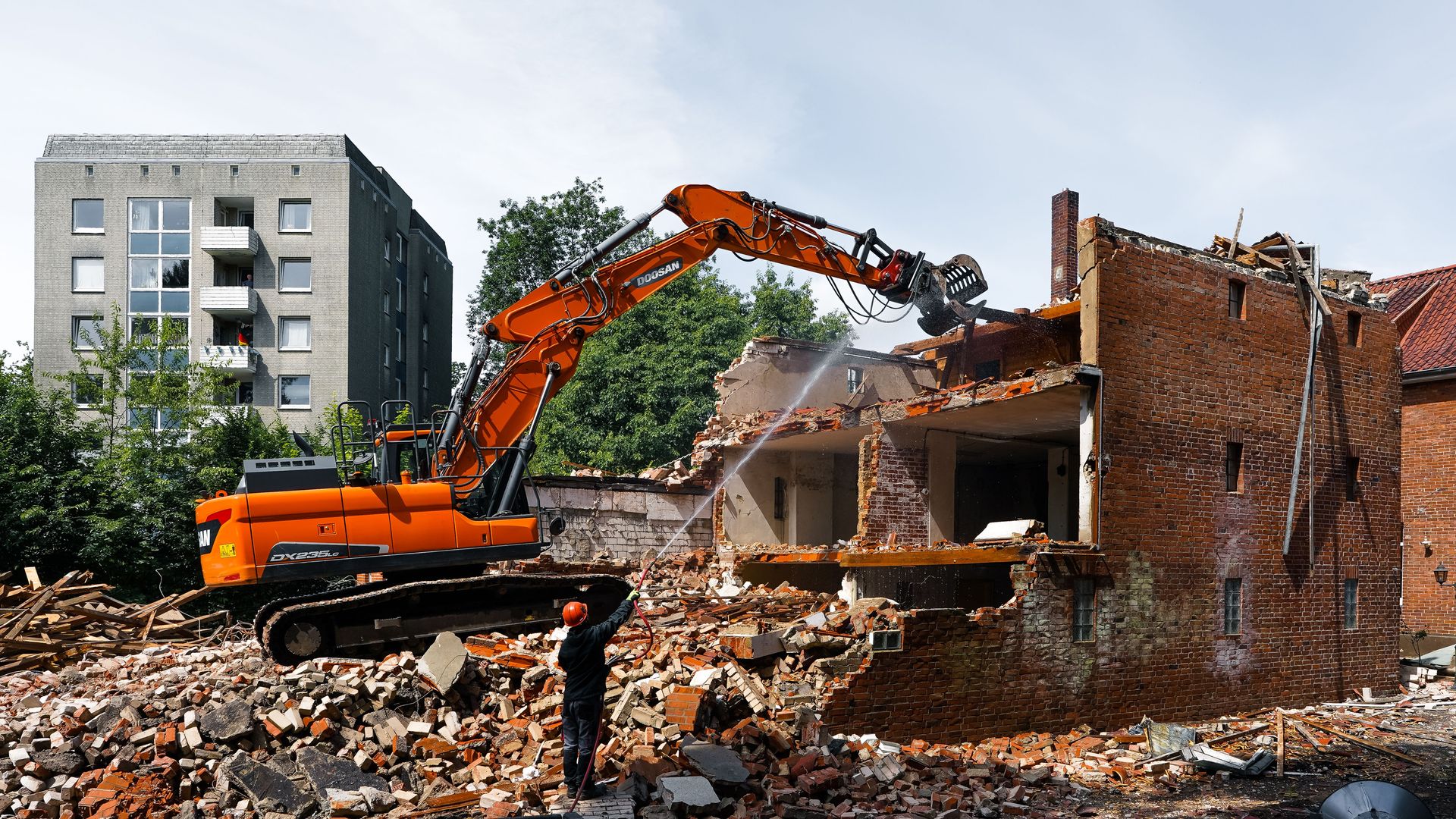 An excavator demolishing an old building in Geesthacht, Germany.